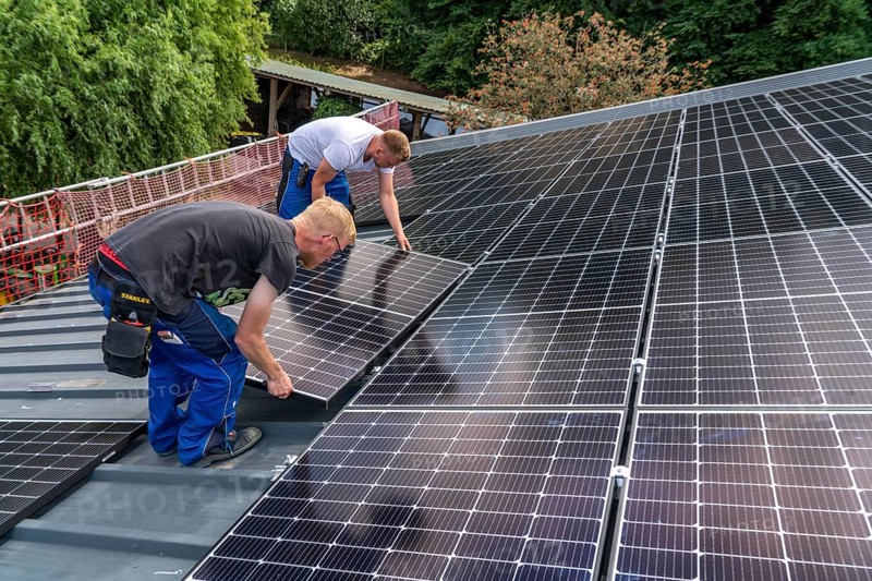 Installation of solar modules on the roof of a barn on a farm, over 210 photovoltaic modules are installed on the roof, North Rhine-Westphalia, Germany, Europe