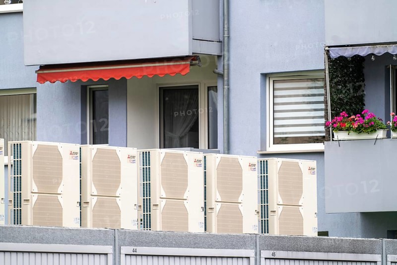 Heat pumps in a residential area, multi-family houses are supplied with heating, cooling and domestic hot water via these devices, installed on garage roofs, modernisation of the flats, Duisburg, North Rhine-Westphalia, Germany, Europe
