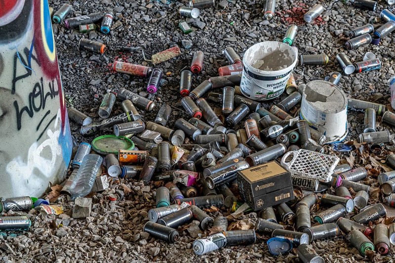 Empty spray paint cans, on a railway line below a road bridge, thrown away, disposed of by the sprayer, graffiti, rubbish heap, Essen, North Rhine-Westphalia, Germany, Europe