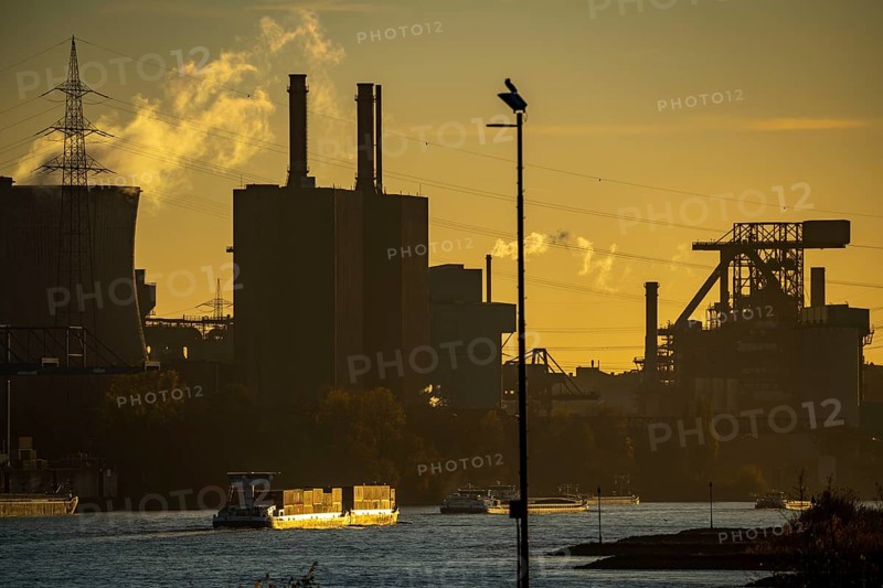 Sunset, cargo ships on the Rhine, steelworks, Hüttenwerke Krupp Mannesmann, cooling towers of the Huckingen gas-fired power station, left, Duisburg, North Rhine-Westphalia, Germany, Europe