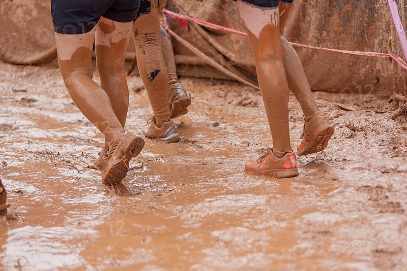 Shoes in the mud during a dynamic outdoor obstacle course