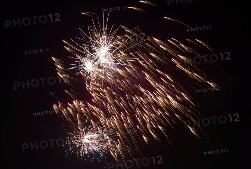 Bright sparks from fireworks spread across the night sky, Lower Saxony, Germany, Europe