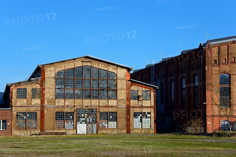 Abandoned industrial building with large windows and brick façade under a blue sky, Ilseder Hütte, Ilsede, Peine district, Lower Saxony, Germany, Europe