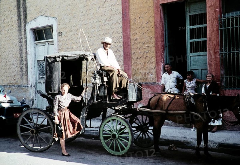Female tourist in front of the Surrey horse-drawn carriage, Mexico, around 1961, Central America