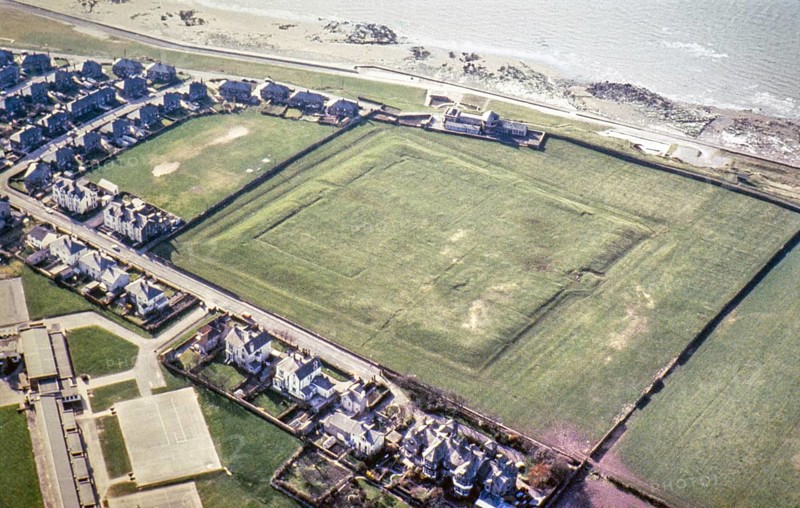 Series of oblique aerial photographs of Roman sites associated with Hadrian's Wall, c. 1970s Earthworks of the Roman coastal fort of Alavna, Maryport, Cumbria, England, UK from a north-easterly direction