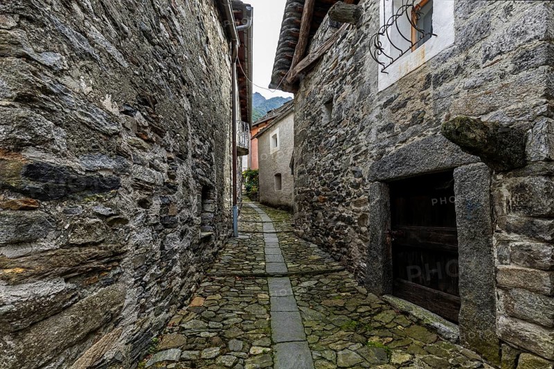 Typical Ticino stone houses in a narrow alley in the mountain village of Bordei, Centovalli, Canton Ticino, Switzerland, Europe
