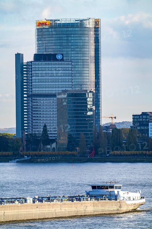 Skyline Bonn on the Rhine, in front the UNFCCC Secretariat of the Framework Convention on Climate Change, in the centre the high-rise building of the United Nations, Campus Bonn, behind it the Posttower, corporate headquarters of Deutsche Post, cargo ship, North Rhine-Westphalia, Germany, Europe