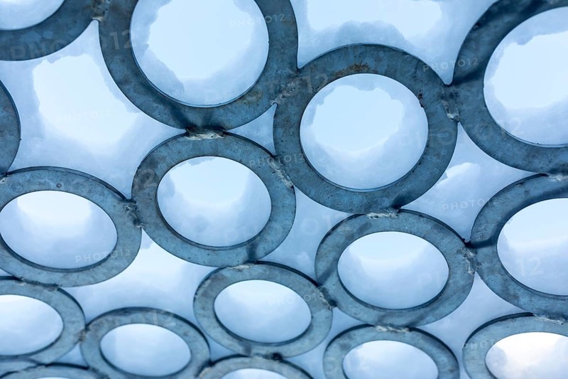 Surface of metal rings, partially covered with snow, detail of the art installation Wunderhorn by Erika Harbort on the former Deutschlandschacht in Oeslnitz in the Ore Mountains, Saxony, Germany, Europe
