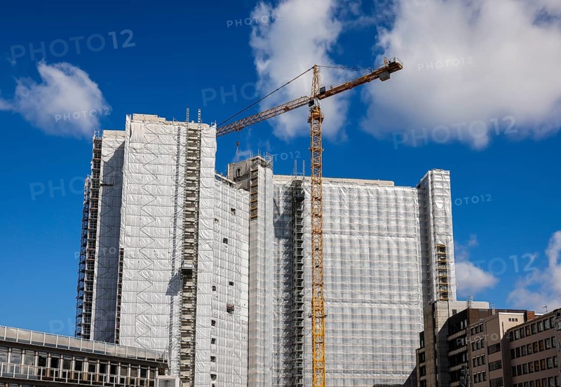 Essen, North Rhine-Westphalia, Germany - Demolition of an office building, demolition of former RWE high-rise building Hyssenallee 2, the Y high-rise from 1980, with 19 floors, 78 metres high, makes way for a new office complex, construction crane in front of scaffolded office building site facade