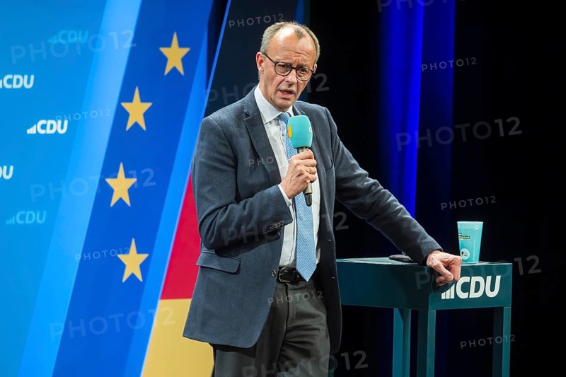 Election event of the CDU party for the Bundestag elections with top candidate Friedrich Merz. Portrait in front of the German flag and the flag of the European Union. Singen am Hohentwiehl. Baden-Württemberg, Germany, Europe