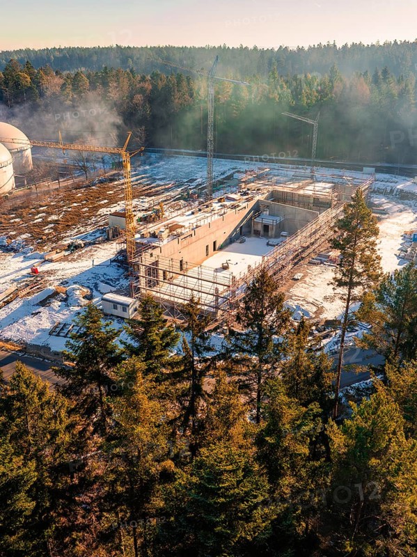 Construction site in the snow, surrounded by trees and a construction crane, under a clear sky, new fire station, Oberhaugsett, district of Calw, Germany, Europe