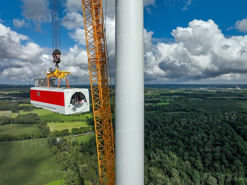 Dorsten, North Rhine-Westphalia, Germany, construction of a wind turbine, the first wind turbine of the Große Heide wind farm. A large mobile crane places the nacelle, the nacelle on the tower, Europe