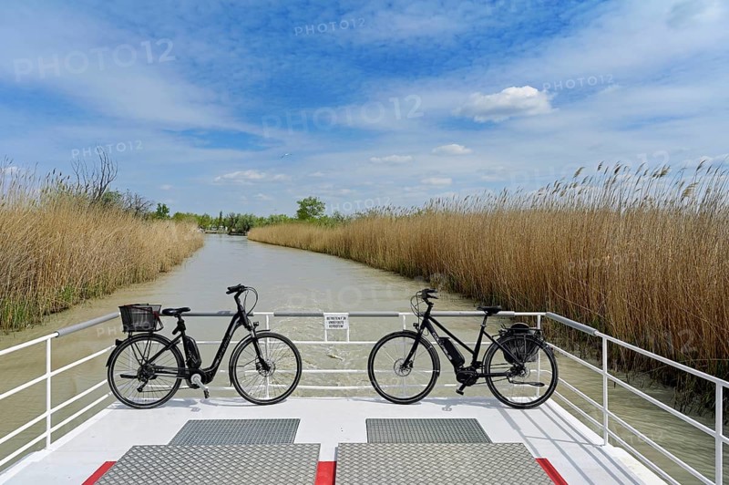 Bicycles on bicycle ferry in the canal, Illmitz, Lake Neusiedl National Park, Seewinkel, Burgenland, Austria, Europe