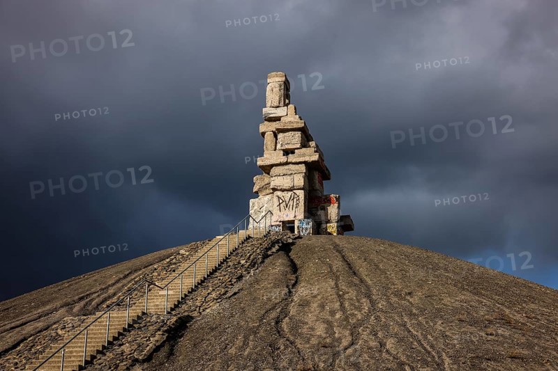 Gelsenkirchen, North Rhine-Westphalia, Germany - Rheinelbe slagheap with artwork Himmelstreppe made of old concrete parts of the former Rheinelbe colliery in front of a dark sky, artist Herman Prigann