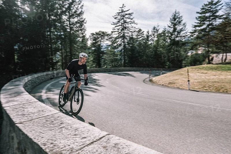 Road bike rider in spring between Lechtal and Tannheimer Tal in front of picturesque scenery of the Alps, Tyrol, Austria, Europe