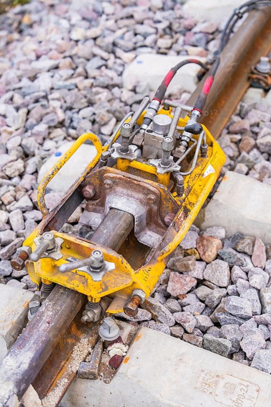 Yellow technical device on the tracks, surrounded by stone ballast, rail welding, track construction Hermann Hessebahn, Calw, Black Forest, Germany, Europe