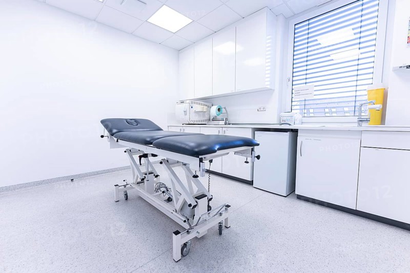Modern clinic room with examination couch and window, bright and sterile, Urology, Germany, Europe