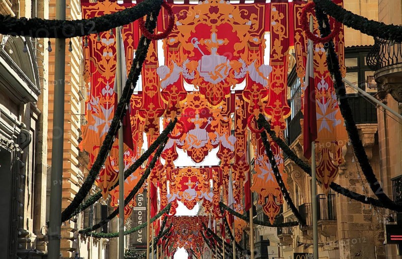 Flags decorate historic street in city centre of Valletta, Malta, Europe