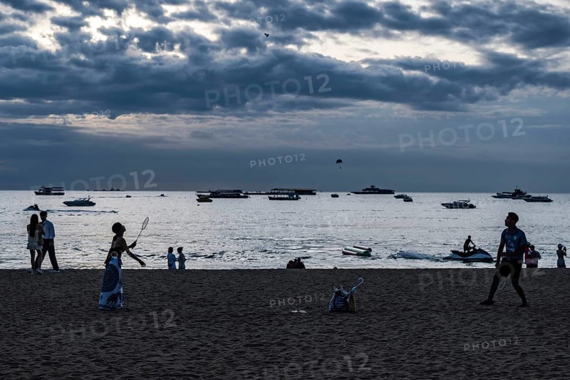 Couple playing badminton on the beach