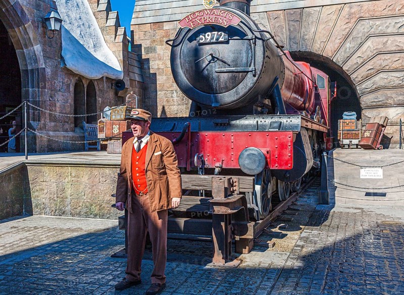 Conductor near train locomotive at Hogsmeade station in The Wizarding World of Harry Potter in Universal Studios, Orlando, Florida, USA, North America