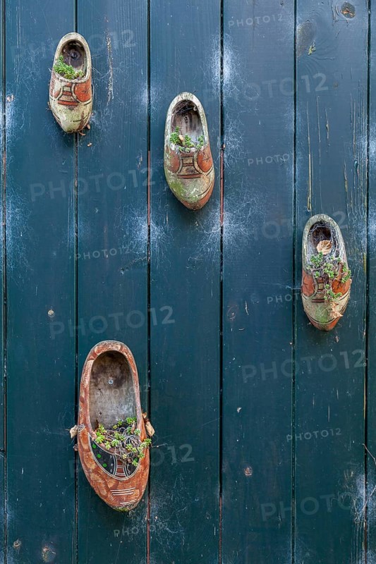 Planted shoes as decoration, wooden gate, Oosterend, North Sea island of Texel, North Holland, Netherlands