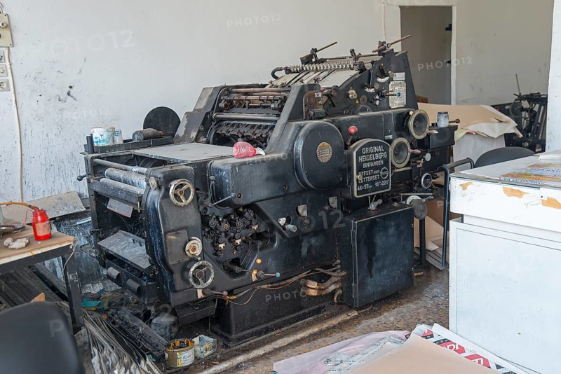 Old offset printing press in a workshop, surrounded by working materials, Heidelberg one-colour offset printing press, Gastouni, Elis, Peloponnese, Greece, Europe