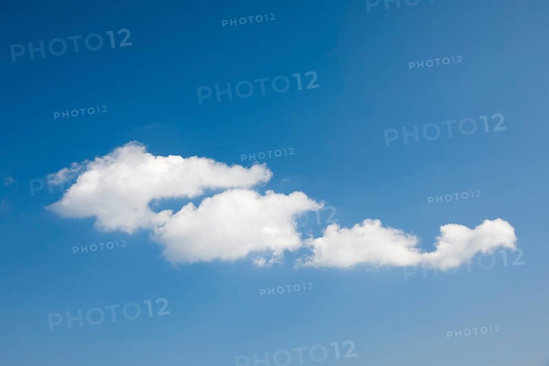 White fleecy clouds adorn the blue sky