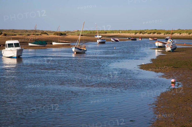 Boats in a tidal creek at Burnham Overy Staithe, north Norfolk coast, England, United Kingdom, Europe