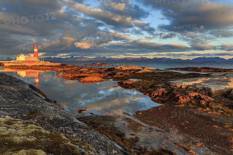 Lighthouse reflected in water, morning light, clouds, mountains, coast, Tranoy, Ofoten, Norway, Europe