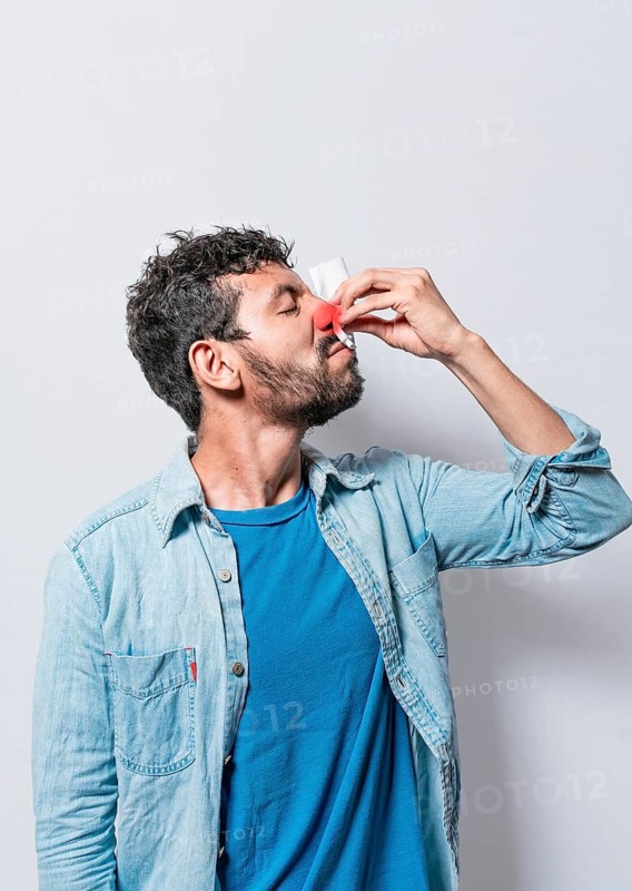 Person with nasal congestion, Person with irritated nose on isolated background, man with red nose cold, concept of person with sinusitis