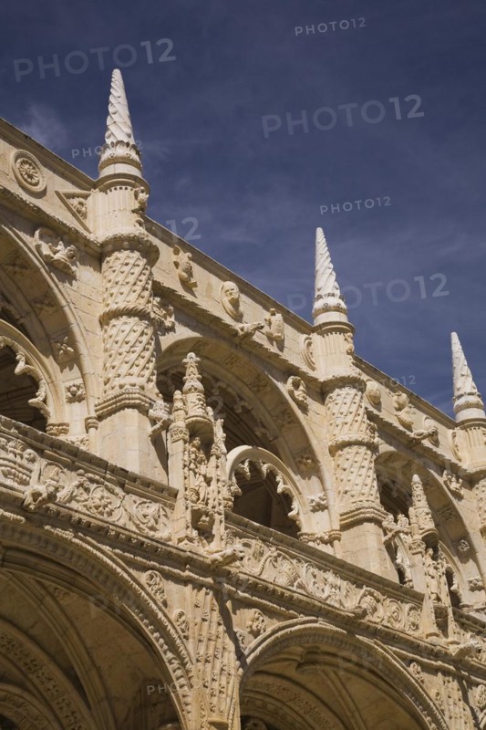 Old architectural building with arches and carved decorative sculptures in the inner courtyard at Jeronimos Monastery, Lisbon, Portugal, Europe
