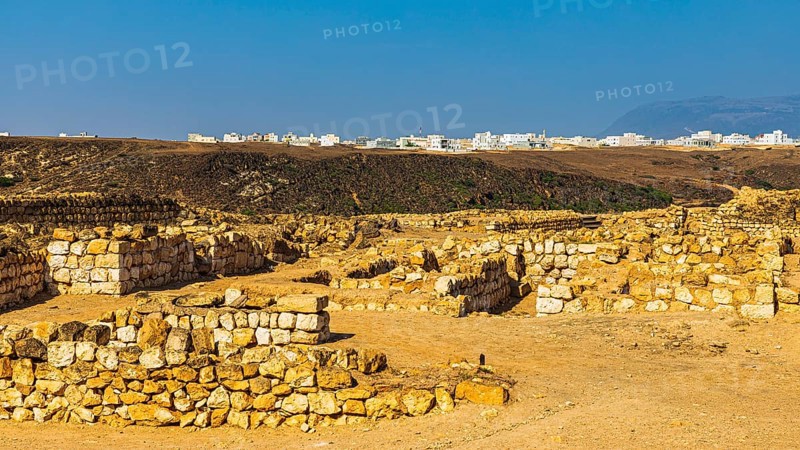 Ancient archaeological site of Sumhuram, near the city of Taqah, behind the modern houses of Taqah, Dhofar Province, Arabian Peninsula, Sultanate of Oman