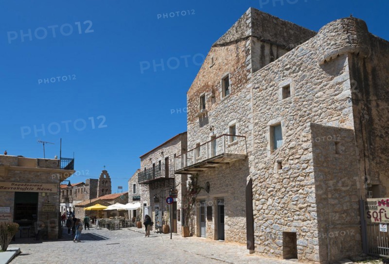 Sunny scene in an old town with historic stone buildings and people walking, Areopoli, Areopolis, Tsimova, Itylo, Anatoliki Mani, Mani, Laconia, Peloponnese, Greece, Europe
