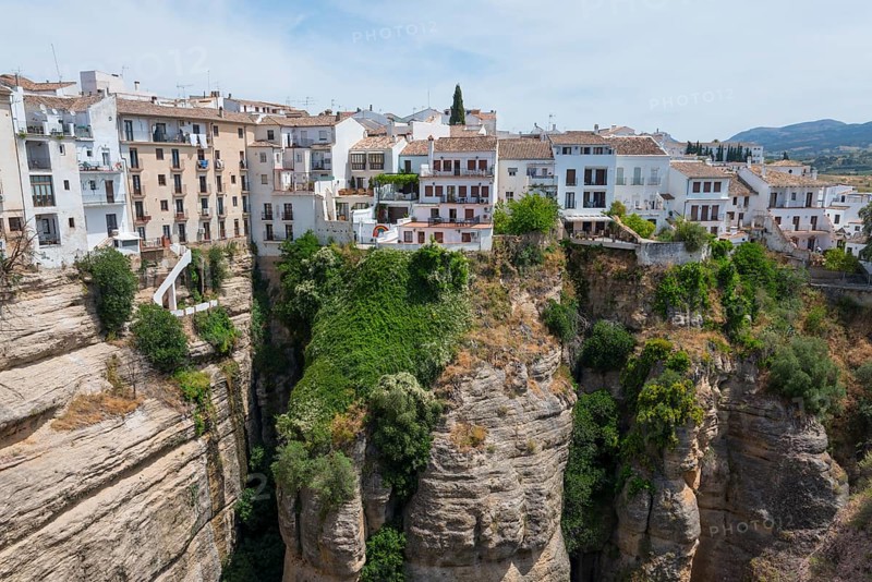 Spanish town with white houses in it situated above a spectacular gorge, view from El Puente Nuevo, the new bridge, old town, Ronda, Málaga province, Malaga, Andalucia, Spain, Europe