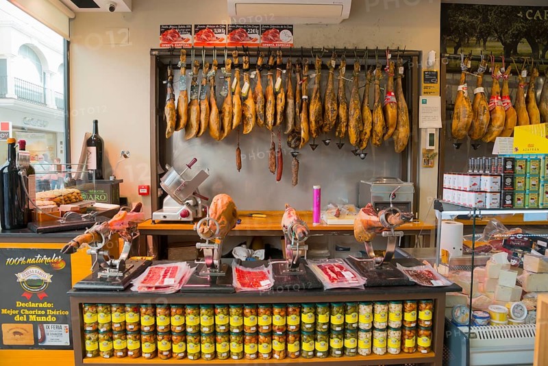 Spanish butcher's shop with a large selection of hung hams and fine sausage specialities, old town, Ronda, Málaga province, Malaga, Andalusia, Spain, Europe