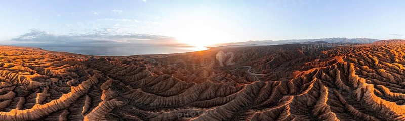 Panorama, landscape of eroded hills, badlands at sunset with Lake Issyk Kul, aerial view, Canyon of the Forgotten Rivers, Issyk Kul, Kyrgyzstan, Asia