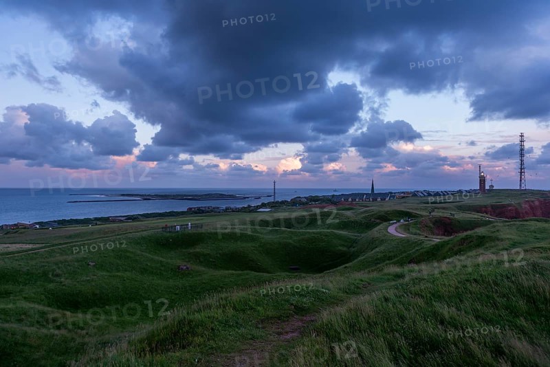 Wavy upland of the offshore island Helgoland with dune, lighthouse, radio tower, hiking trail, cloudy sky, evening shot, Schleswig-Holstein, Germany, Europe