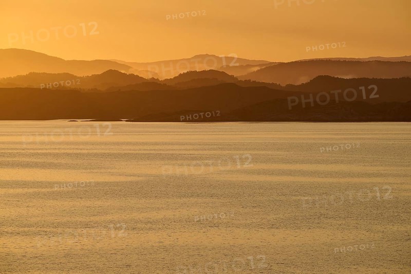 Calm atmosphere over the sea, hills and an orange sunrise, autumn, Bergen, North Sea, Norway, Europe