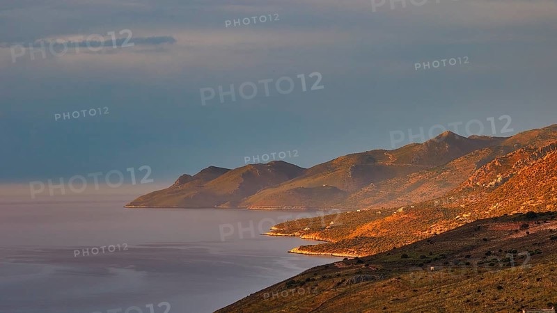 Golden morning sun illuminates a coastal landscape with mountains and sea, Mani Peninsula, Peloponnese, Greece, Europe