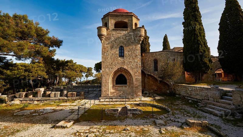 St John's Church, remains of an ancient baptismal font, remains of the Temple of Athena Polias, historic stone tower with red domes and surrounding trees under a sunny blue sky, Filerimos, hill not far from Rhodes town, Ancient State of Ialyssos, Rhodes, Dodecanese, Greek Islands, Greece, Europe