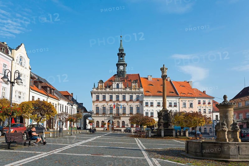 Historic town square with Baroque-style buildings and clock tower under a blue sky, town hall, plague column column of the Holy Trinity and fountain, Ceská Lípa, Bohemian Leipa, Leipa, Liberecký kraj, Bohemia, Czech Republic, Europe