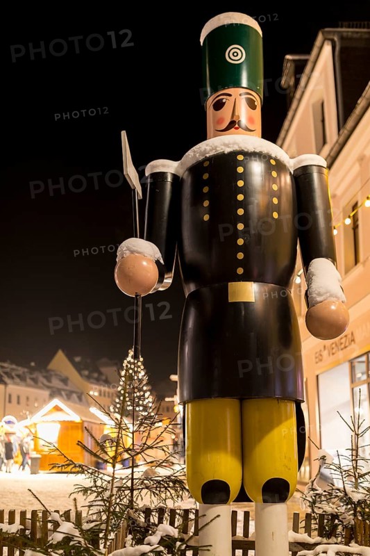 Larger-than-life wooden figure of a miner at the entrance to the Christmas market in Schneeberg in the Erzgebirge, Saxony, Germany, Europe