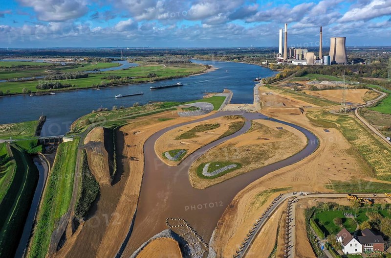 Dinslaken, Voerde, North Rhine-Westphalia, Germany, Inauguration of the new Emscher estuary into the Rhine. The decommissioned STEAG Voerde coal-fired power station is in the background. The mouth of the Emscher into the Rhine has been moved almost 500 metres north from Dinslaken to Voerde. Fish can now swim barrier-free up the new Emscher from the Rhine through a newly created floodplain area. Following the construction of a parallel sewer, the Emscher has been completely free of sewage since January 2022. The river was previously an open, above-ground combined sewer with rainwater and wastewater, Europe