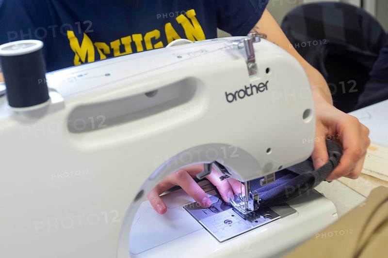 Detroit, Michigan - Volunteers repair various items during the monthly Repair Cafe at the Knapp Branch of the Detroit Public Library. Diana Graham uses a sewing machine for a repair. The Repair Cafe movement aims to reduce waste and save money by fixing, instead of discarding, broken items