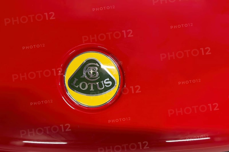 Close-up of logo of car brand sports car manufacturer Lotus from 2010 to, 2019 on red bonnet bonnet of sports car, international