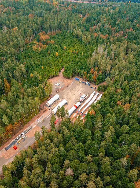 Construction site in the forest with wind power components surrounded by colourful autumn leaves, aerial view, wind farm construction site, Grömbach, Black Forest, Germany, Europe