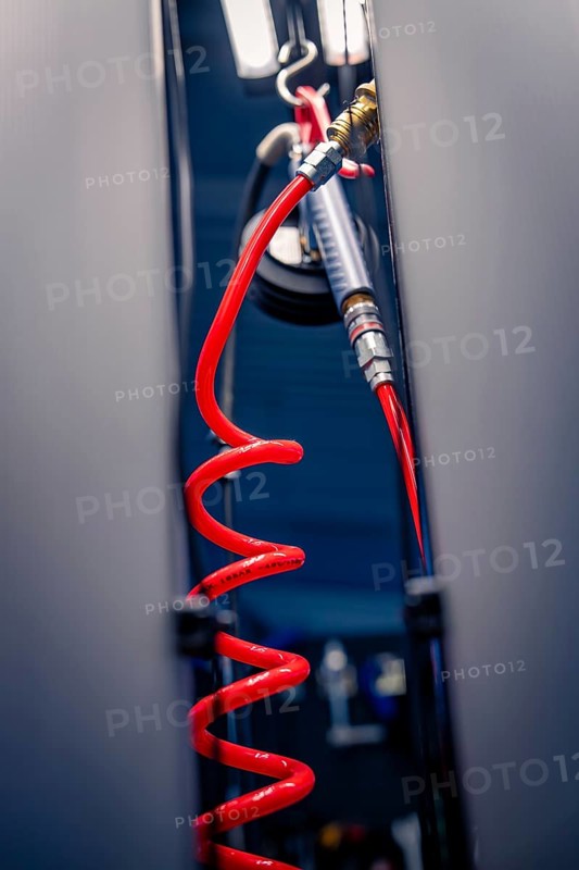 Red spiral tube in the technical environment of a workshop, focus on tool details, Waldbike Manufaktur, bicycle workshop, Calw, district of Calw, Black Forest, Germany, Europe