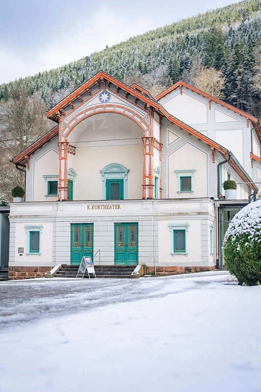 Historic theatre building in the snow, surrounded by wooded mountains, Königliches Kurtheater, Bad Wildbad, Black Forest, Germany, Europe