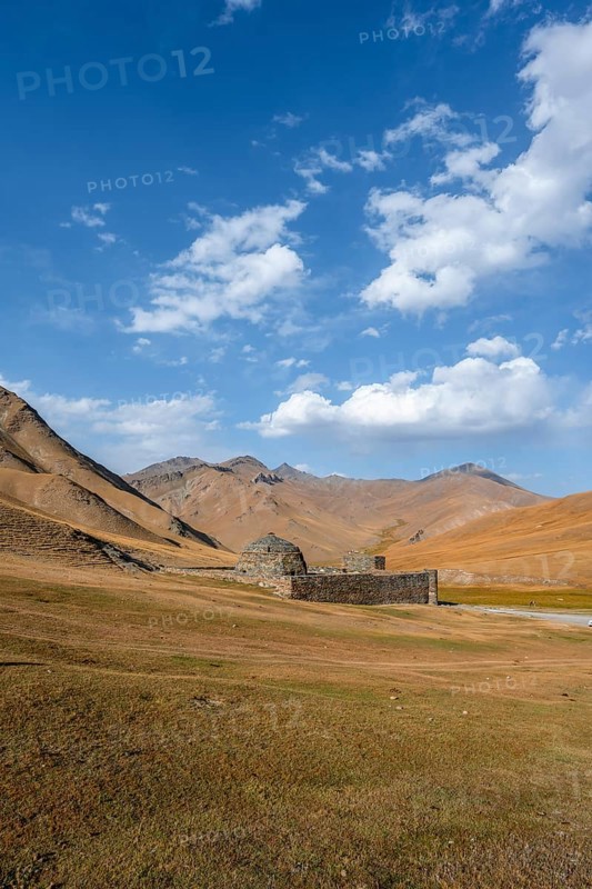 Historic caravanserai Tash Rabat from the 15th century, with yellow hills, Atbashy district in the Naryn region, Kyrgyzstan, Asia