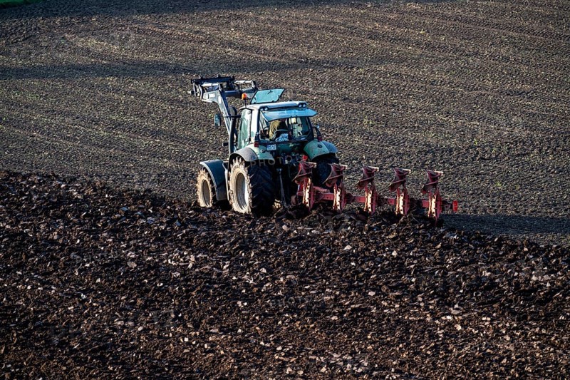 Farmer ploughing a field, tractor with plough, near Neuss, North Rhine-Westphalia, Germany, Europe